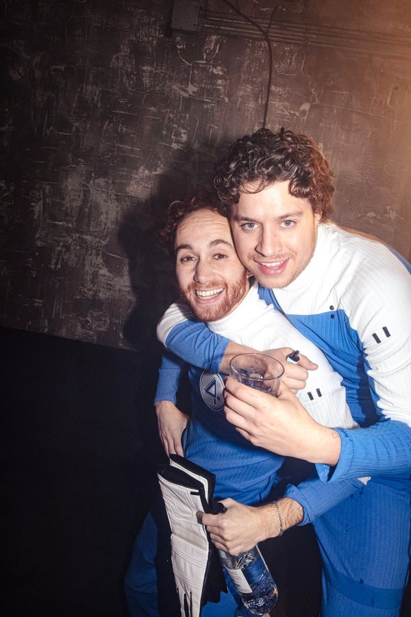 Two friends in matching blue-and-white suits
