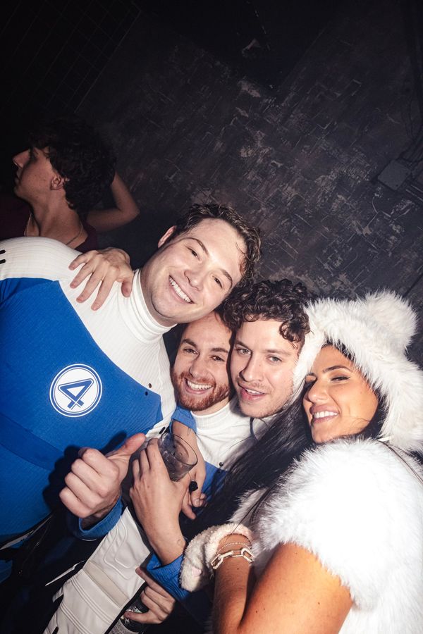 Four friends in costume posing together