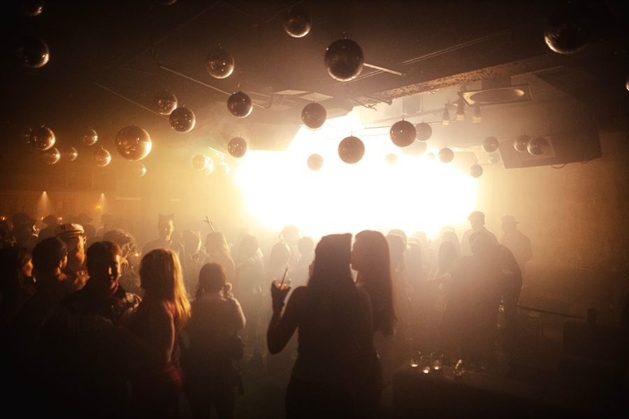 A hazy crowd under dozens of disco balls
