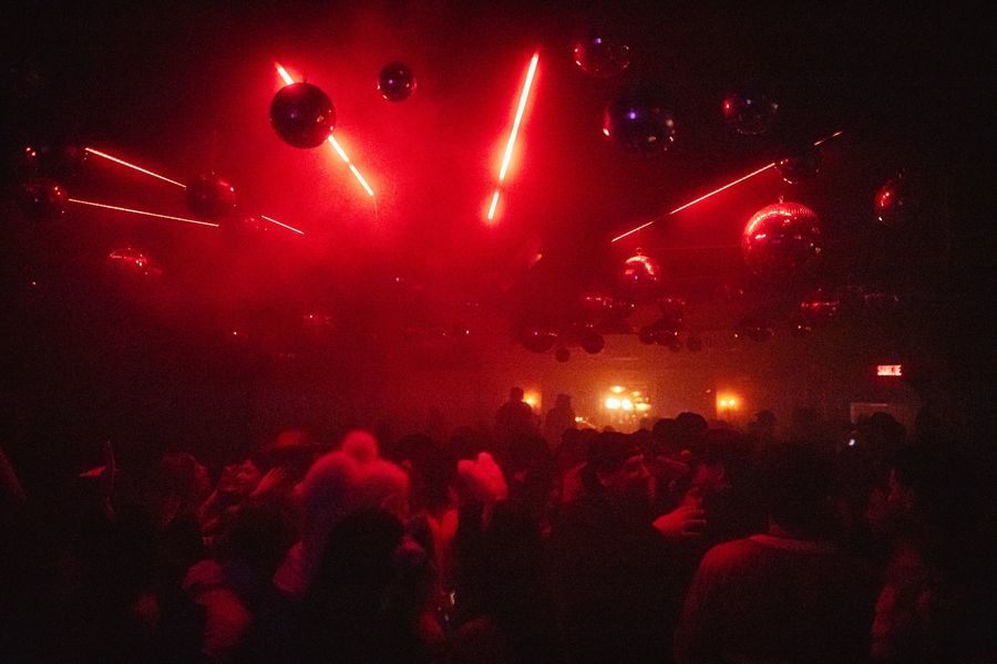 Red lasers and disco balls over the dance floor