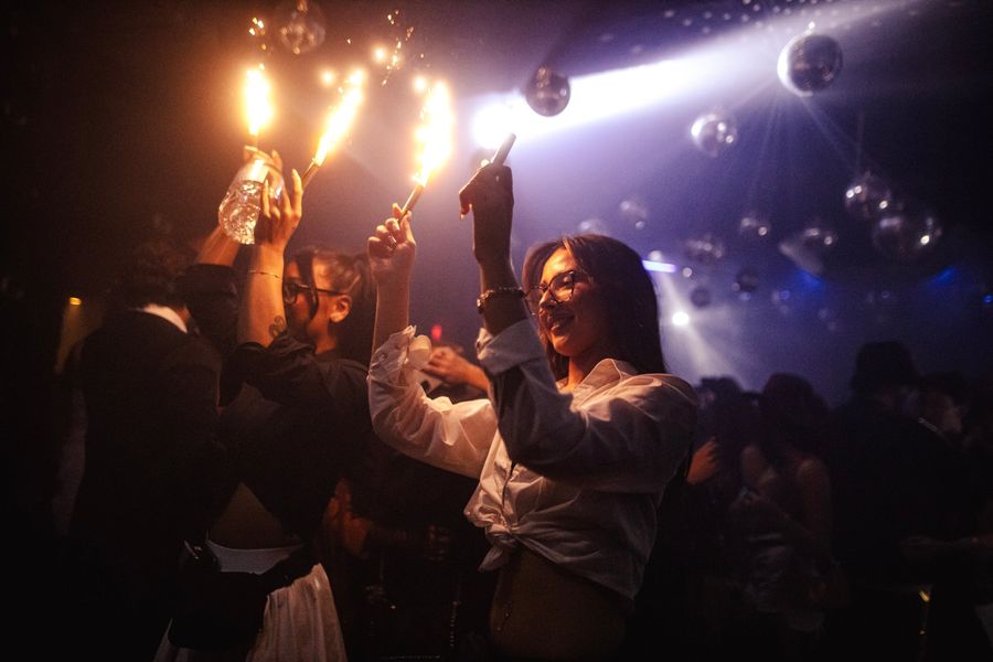 Guests raising sparklers on the dance floor