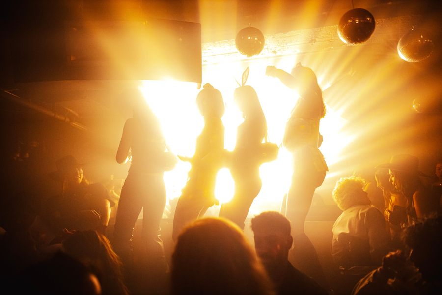 Dancers on stage silhouetted in golden light